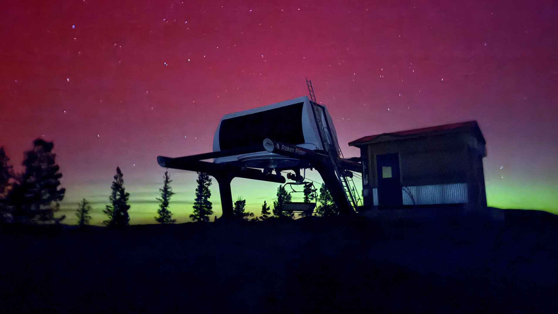 Chairlift terminal silhouetted against a vivid night sky, illustrating the scale and reliability of modern lift infrastructure delivered by Leitner-Poma of America during the 2025 build season.